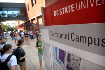 pupils chat while waiting around for a bus during the Textiles complex on Centennial Campus.